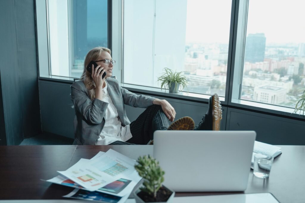 Executive woman smiling while using mobile phone, symbolizing confidence, connection, and modern leadership
