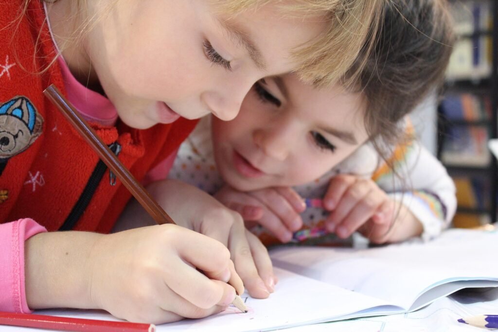 Happy children immersed in writing, symbolizing curiosity, creativity, and the joy of learning