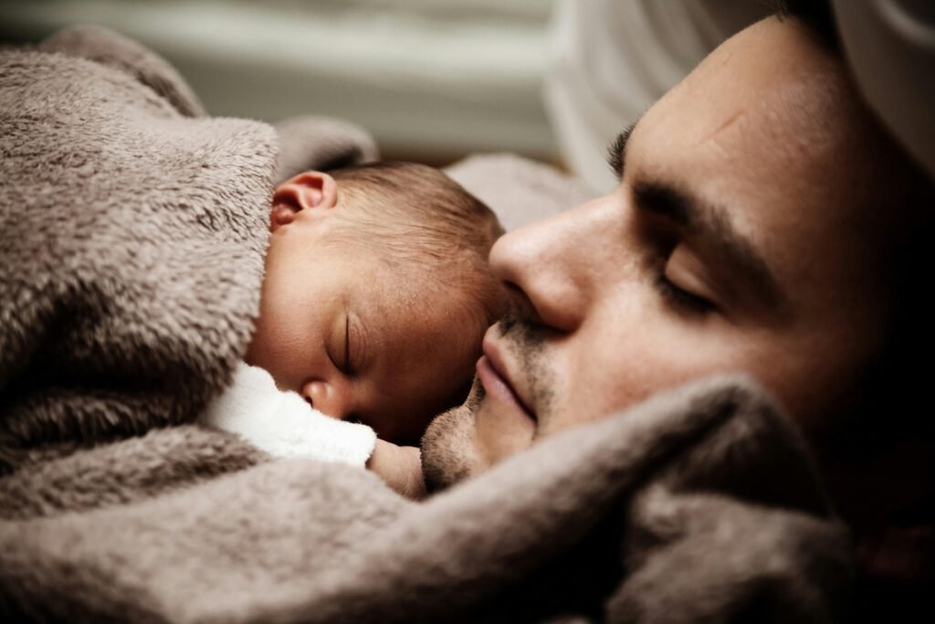 Newborn sleeping peacefully on father’s chest, symbolizing love, protection, and the bond of parenthood