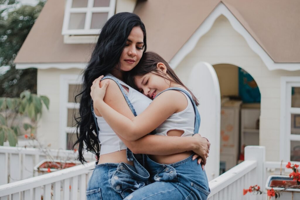 Tired woman gently hugging her daughter, showing love and need for self-care