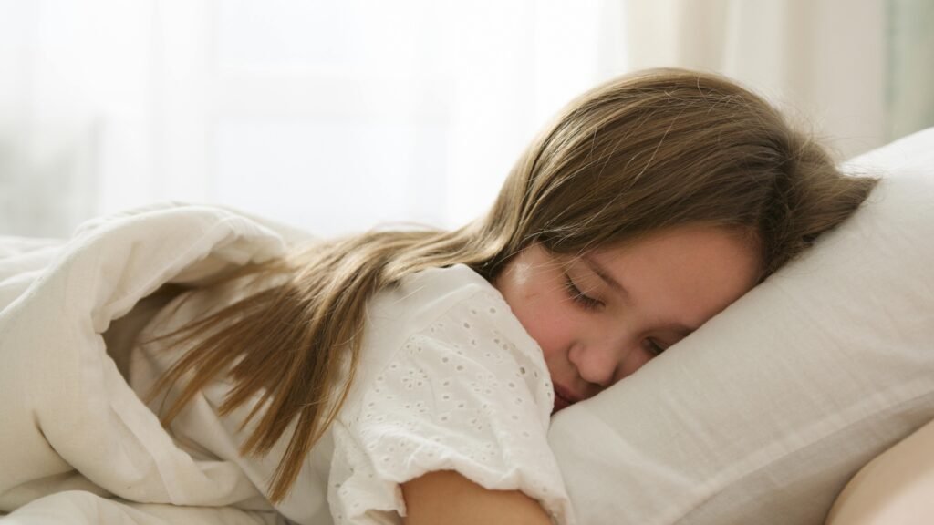 Young child resting quietly in bed, enjoying a calm sleep