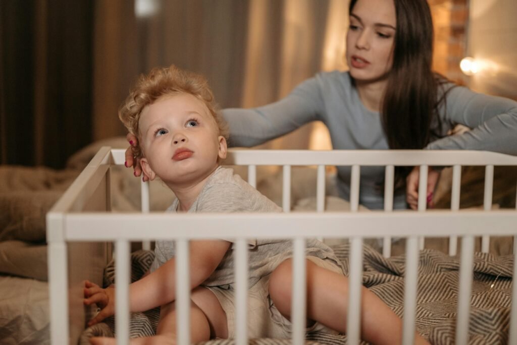 Mother gently caressing her child in crib, showing love and comfort
