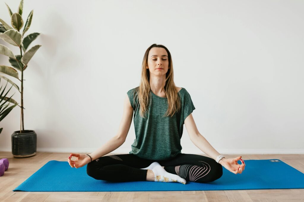 Mother practicing yoga alone at home during her free time for relaxation and wellness